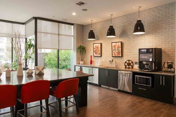 A modern kitchen with a dining table and chairs.